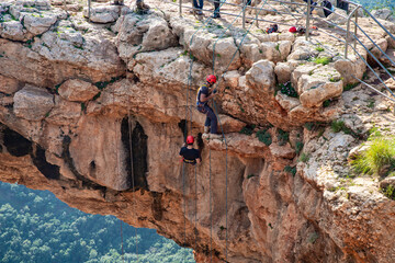 Two athletes make the descent on a rope down - climbing - snapping - the rope from the mountain to Keshet, Cave in northern Israel.