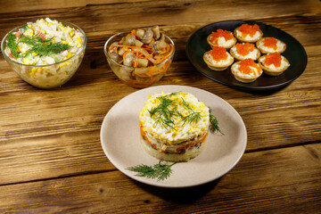 Set of various festive dishes on a wooden table