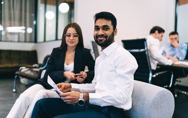 Cheerful colleagues working together in modern workspace