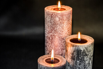 Burningh candles against a black background