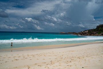 Fototapeta na wymiar Seychelles La Digue Grand Anse South beach Indian ocean waves girl