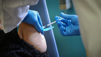 Vaccination Against Covid-19, a person receives the Pfizer's coronavirus vaccine