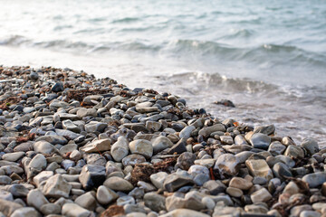 Stones on the beach on the background of the sea