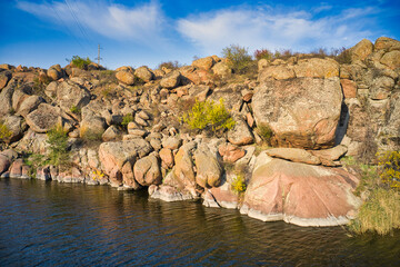 A smooth shining stream flows among large boulders © YouraPechkin
