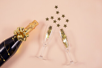 Champagne bottle with golden ribbons and confetti