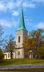 Stone church in the city of Gustavsberg against the background of the spring sky