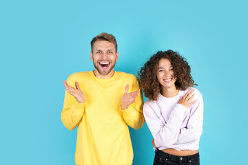Fototapeta premium Two mixed race people standing on blue background
