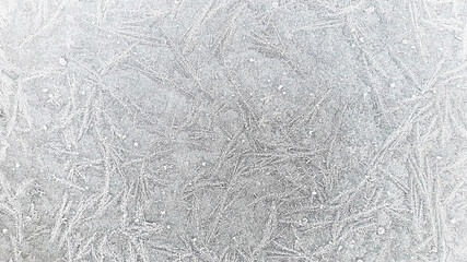 Frosty pattern on glass in winter. Abstract background