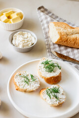 Homemade mushroom pate and sandwiches. White baguette with mushroom paste on a white plate.