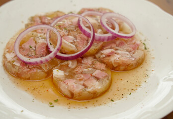 white collared pork with onion rings in vinegar an oil