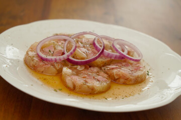 white collared pork with onion rings in vinegar an oil