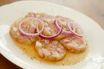 Obraz na płótnie Canvas white collared pork with onion rings in vinegar an oil