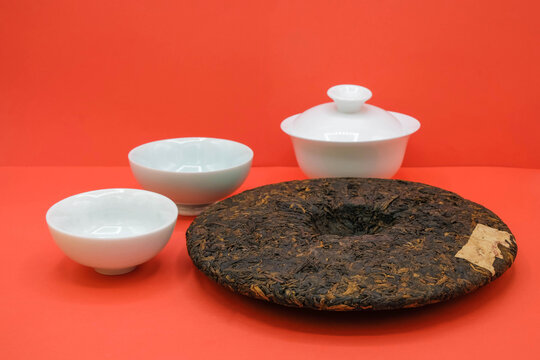 A Puerh tea from China and porcelain tea set on a red background. Tea tasting. Tea ceremony. Slow down. Life philosophy. Healthy food. 