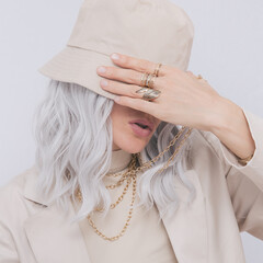 Urban street style Blonde. Details of everyday look. Casual beige outfit and accessories. Bucket...