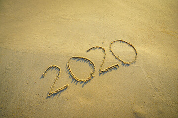 Year 2020 inscription written on the sandy beach. New year conceptual.