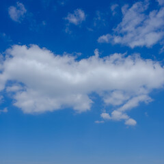 The white clouds on the clear blue sky