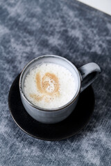 Coffee with milk. Wooden background. Close up.