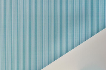 Background in pastel blue, white tones. Repeating stripes on a blue background