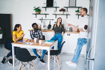 Positive diverse coworkers chatting about project