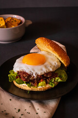 burger with fries and egg