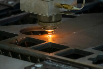 The fiber laser cutting machine cutting  machine cut the metal plate. The hi-technology sheet metal manufacturing process by laser cutting machine.