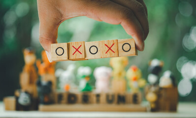 Hand holding O and X symbol print screen on wooden cube mean of correct or incorrect mindset...