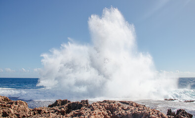 Fototapeta na wymiar waves crashing on rocks Australia
