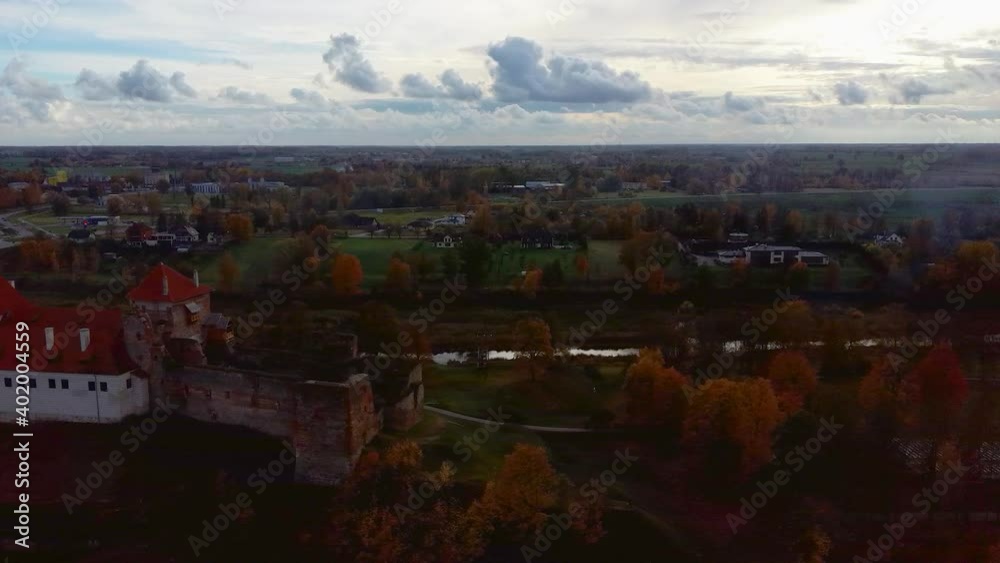 Wall mural Bauska Medieval Castle Ruins Complex and Park From Above Aerial Shot. Ruins of the Livonian Part of the Bauska Castle, Latvia in Autumn. Castle Was Built in the Middle of the 15th Century