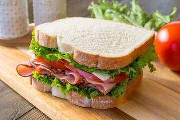 Ham and cheese sandwhich on cutting board