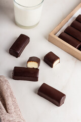 Glazed curds in chocolate in a cardboard box. Dessert with glazed cheese.