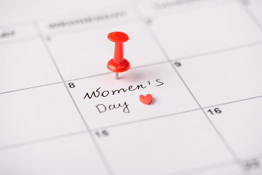 Waiting for international women's day concept. Cropped close up view photo of red drawing pin on calendar marked 8 march