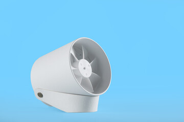 Modern electric fan on light blue background