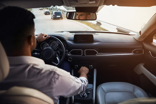 Handsome Man Driving His Modern Car, View From Backseat