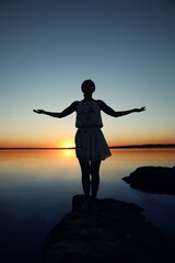 Woman near river on sunset. Healing concept