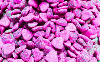 candy heart for Valentine's day. Candy A lot of sweets. Colorful texture using a background. Background rendering. Bright multiple jelly candies in powdered sugar. Confectionery wallpaper concept