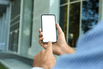 Man using modern mobile phone outdoors, closeup