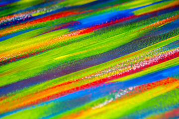 Background from different strokes of red, yellow, green and blue paint