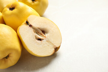 Naklejka na ściany i meble Fresh ripe organic quinces on light table, closeup. Space for text