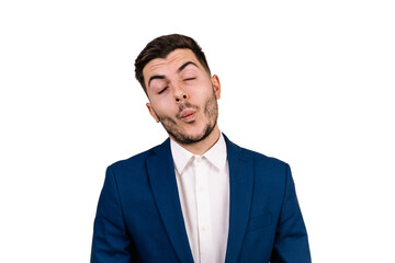 young man with dark hair dressed in a suit making a funny expression with his face isolated on a white background