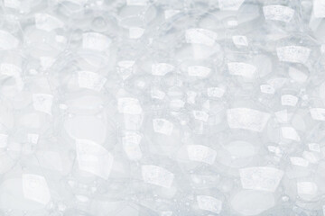 Background of soap foam and bubbles on a white background, macro photography