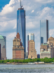 Fototapeta na wymiar NEW YORK CITY - JUNE 11, 2013: Tourists in Governors Island with Manhattan view