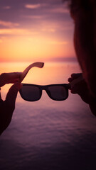 Sunglasses with polarized lens over sea-view background at sunset, protection eyes 
