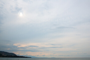 People swimming in calm Mediterranean sea in Sicily (Italy) at sunset