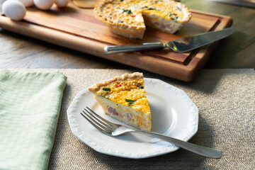 Slice of Quiche Lorraine on a white plate