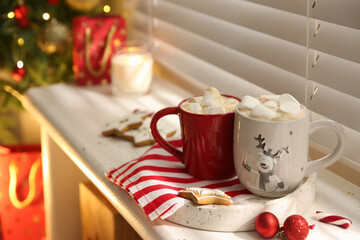 Composition with cup of hot drink on windowsill