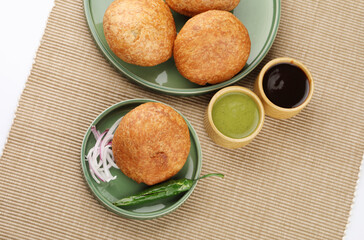 Indian teatime snack called Kachori or kachodi served with mint and tamarind dip or chutney. This is a popular in North and Central India