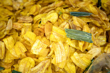Fried sliced banana snack crisp which is selling in local market. Food and texture photo. 
