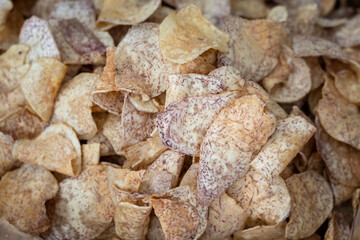 Fried sliced taro snack crisp which is selling in local market. Food and texture photo. 