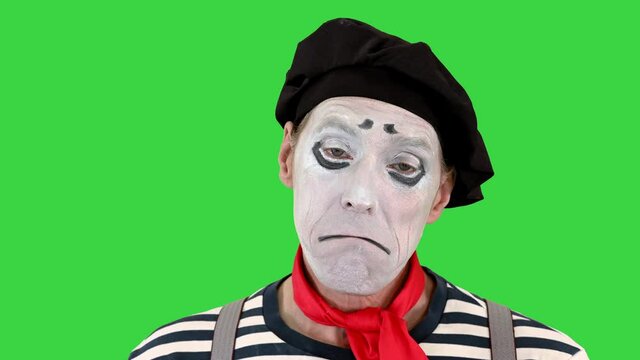 Sad mime looking to camera on a Green Screen, Chroma Key.