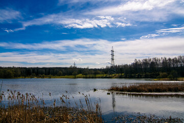 Fototapeta na wymiar landscape with lake and power line tower